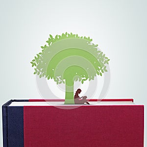 Book with girl reading under the tree paper cut