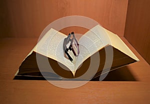 Book and glasses at night