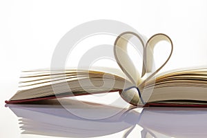 Book with heart from book pages stands for exciting stories and reading enjoyment.