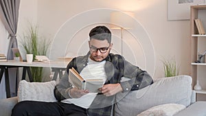 Book leisure home smart man reading couch glasses