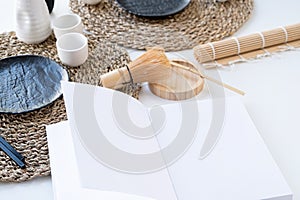 Book mockup design. Blank white book on dining table in asian style with tableware