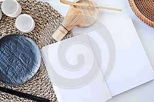 Book mockup design. Blank white book on dining table in asian style with tableware