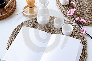 Book mockup design. Blank white book on dining table in asian style with tableware