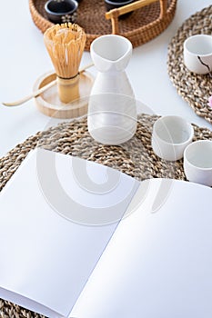 Book mockup design. Blank white book on dining table in asian style with tableware