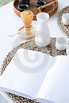 Book mockup design. Blank white book on dining table in asian style with tableware