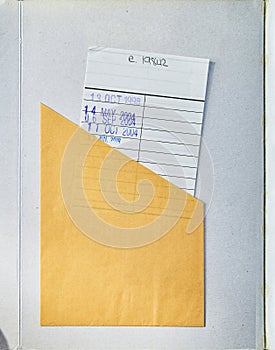 A Book opened showing textured cover with a Check Out card