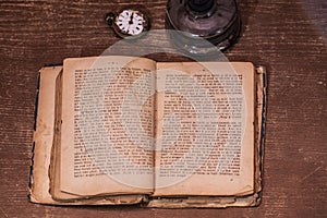 A book over a hundred years old and a watch from 1850