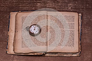 A book over a hundred years old and a watch from 1850