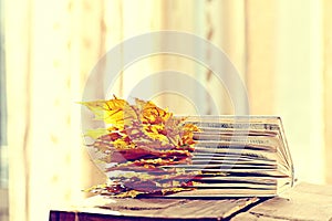 Book pages with dry autumn leaves