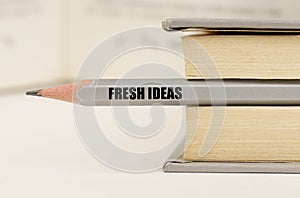 In the book between the pages lies a pencil with the inscription - Fresh Ideas