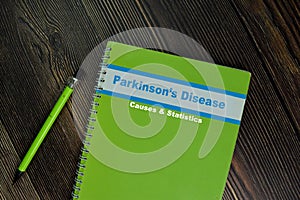 The Book of Parkinson\'s Disease Cause and Statistics isolated on Wooden Table. Medical or Healthcare concept