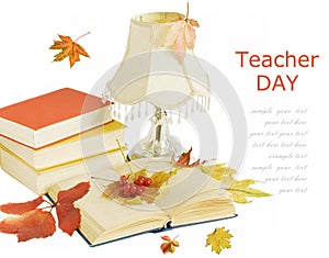 Book pile with apple, globe, pencils and sharpener on the school blackboard. Teacher`s day concept