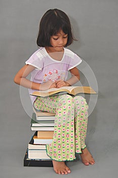 Book reading enthusiast of young Malaysian girl