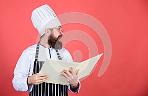 Book recipes. According to recipe. Man bearded chef cooking food. Culinary arts concept. Amateur cook read book recipes