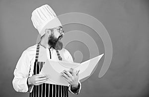 Book recipes. According to recipe. Man bearded chef cooking food. Culinary arts concept. Amateur cook read book recipes