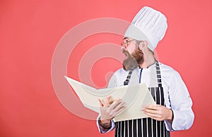 Book recipes. According to recipe. Man bearded chef cooking food. Culinary arts concept. Amateur cook read book recipes