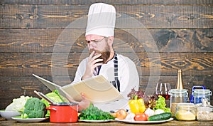 Book recipes. According to recipe. Man bearded chef cooking food. Guy read book recipes. Culinary arts concept. Man