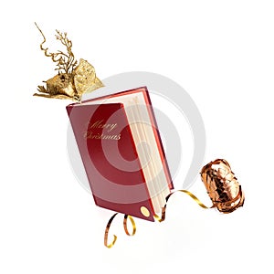 Book in red cover with golden christmas decor isolated on a white background