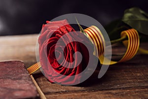 Book, red rose and catalan flag