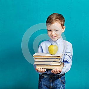 Book, school, kid. little student holding books. Cheerful smiling little kid against chalkboard.