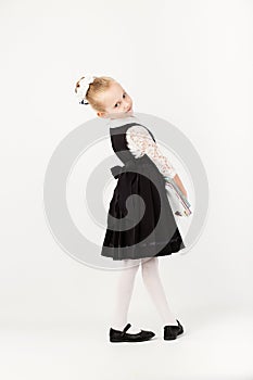 Book, school, kid. little student holding books. Cheerful smiling little kid against chalkboard. Looking at camera. School