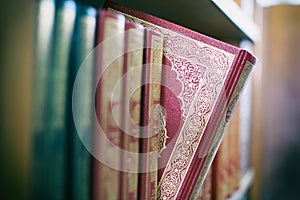 A book is selected from bookshelf in public library