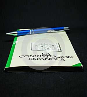 Book of the spanish constitution wiht a pen and the graphical white background photo