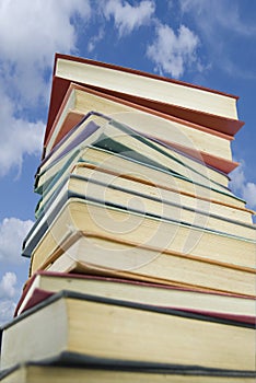 Book stack against a summers sky