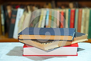 Book, stack of hardback books on table. Top view.