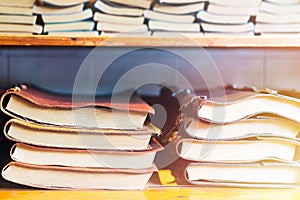 Book stack on wooden shelf, colorful leather cover book