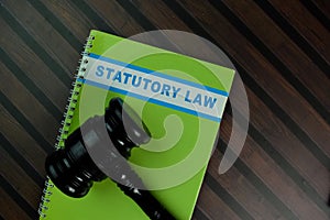 The book of Statutory Law isolated on Wooden Table. Law concept