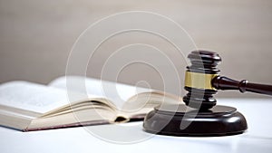 Book on table, gavel standing on sound block, government constitution, law order