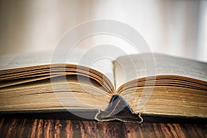 Book or textbook open old, black cover, close-up, selective focus