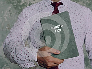 Book with title COMMON LAW . Common law is a body of unwritten laws based on legal precedents established by the courts