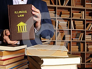 Book with title ILLINOIS LAW . Illinois residents are subject to Illinois state and U.S. federal laws