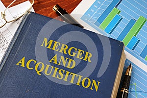 Book with title Merger and Acquisition. photo