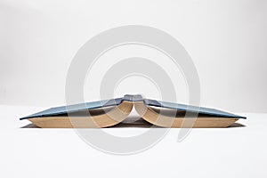 Book up side down on white background.