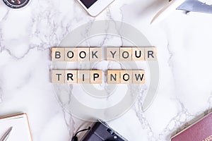 Book your trip now invitation poster with text and luxury travel accesories
