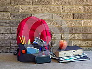 Bookbag With School Asseccories and Stack of Books photo