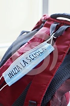 Bookbag and text back to school in Italian in mask photo
