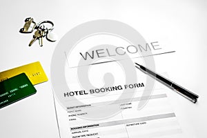 booking hotel room application form and keys white desk backgrou