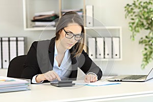 Bookkeeper doing accounting at office photo
