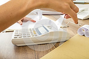 Bookkeeper doing calculations on an adding machine