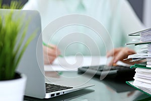 Bookkeeper or financial inspector making report, calculating or checking balance. Binders with papers closeup. Audit an