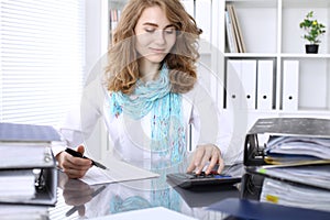 Bookkeeper or financial inspector making report, calculating or checking balance. photo