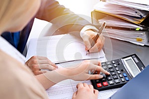 Bookkeeper or financial inspector and secretary making report, calculating or checking balance. Internal Revenue Service