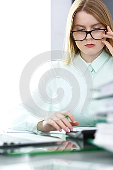 Bookkeeper or financial inspector woman making report, calculating or checking balance. Audit and tax service concept