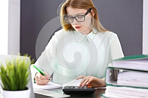 Bookkeeper or financial inspector woman making report, calculating or checking balance. Audit and tax service concept