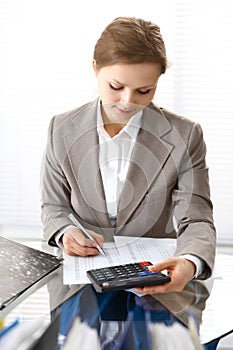 Bookkeeper woman or financial inspector making report, calculating or checking balance. Business portrait. Copy spac