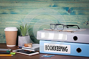 Bookkeeping concept. Binders on desk in the office. Business background photo